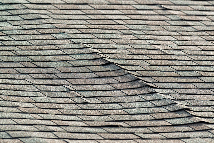 a close up of a roof with shingles that are missing .