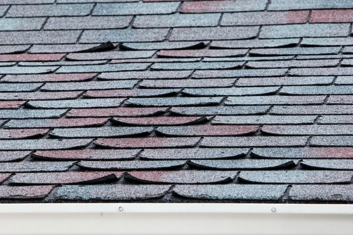 a close up of a roof with a lot of shingles missing .