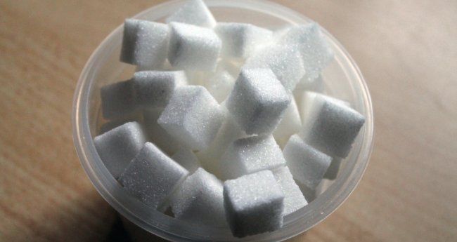 a plastic bowl of sugar cubes