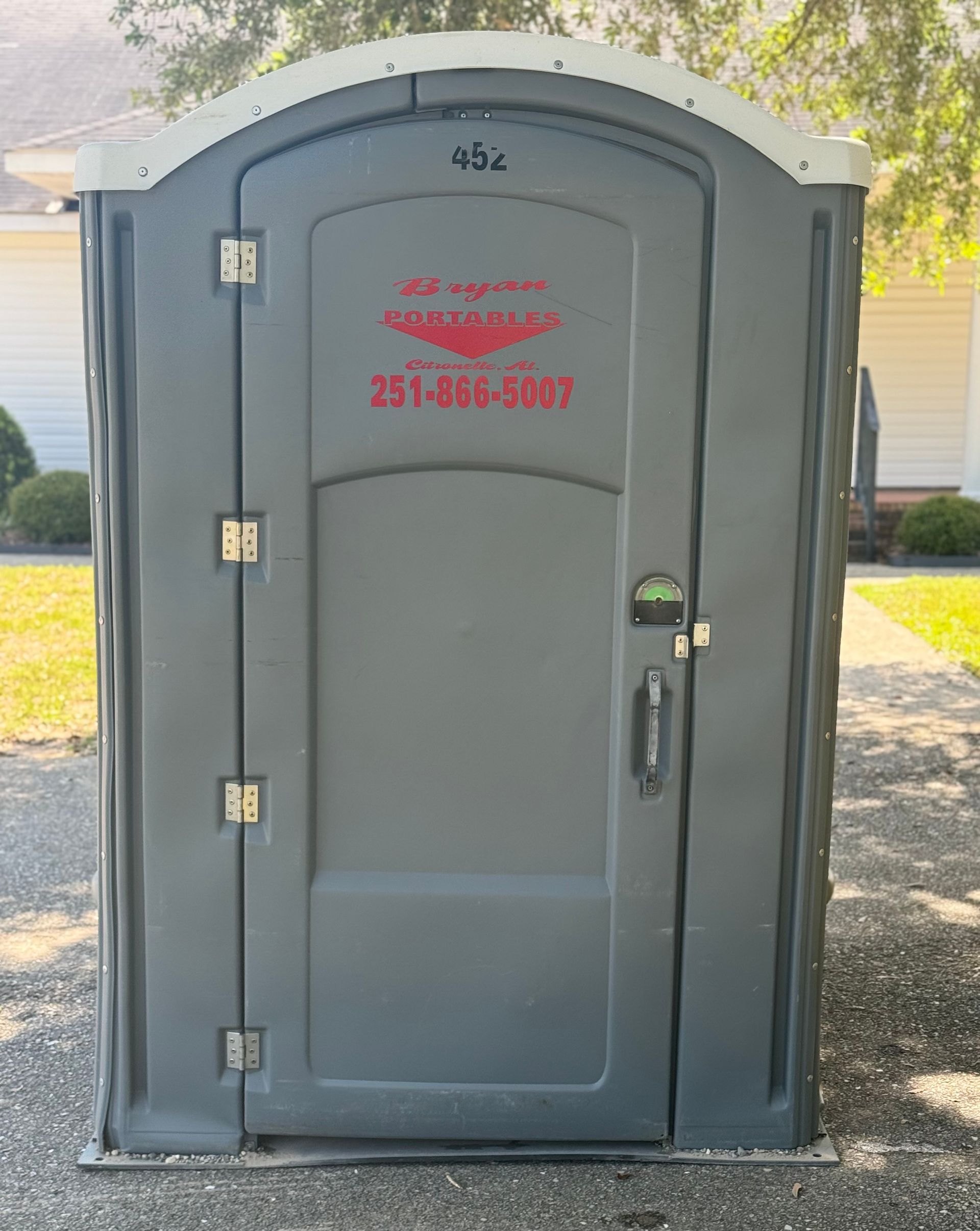 A portable toilet with a phone number on it