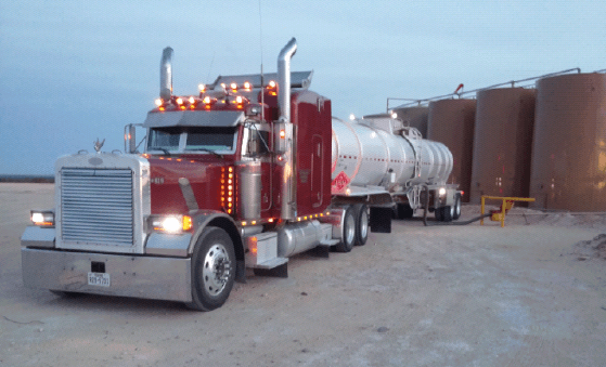 Red crude oil transport hauler in West Texas oil field