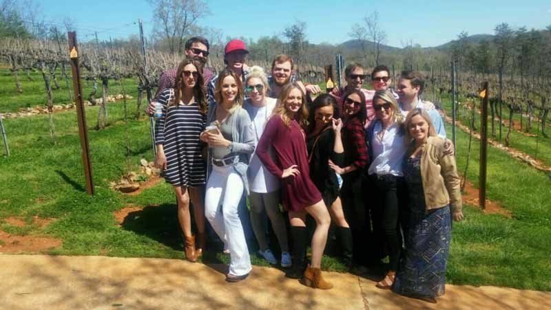 group of people on a wine tour in vineyard