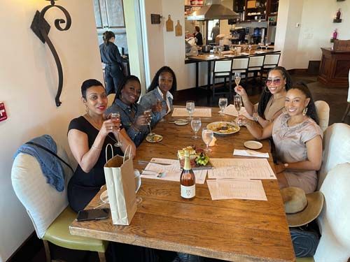 group of people enjoying wine at a table