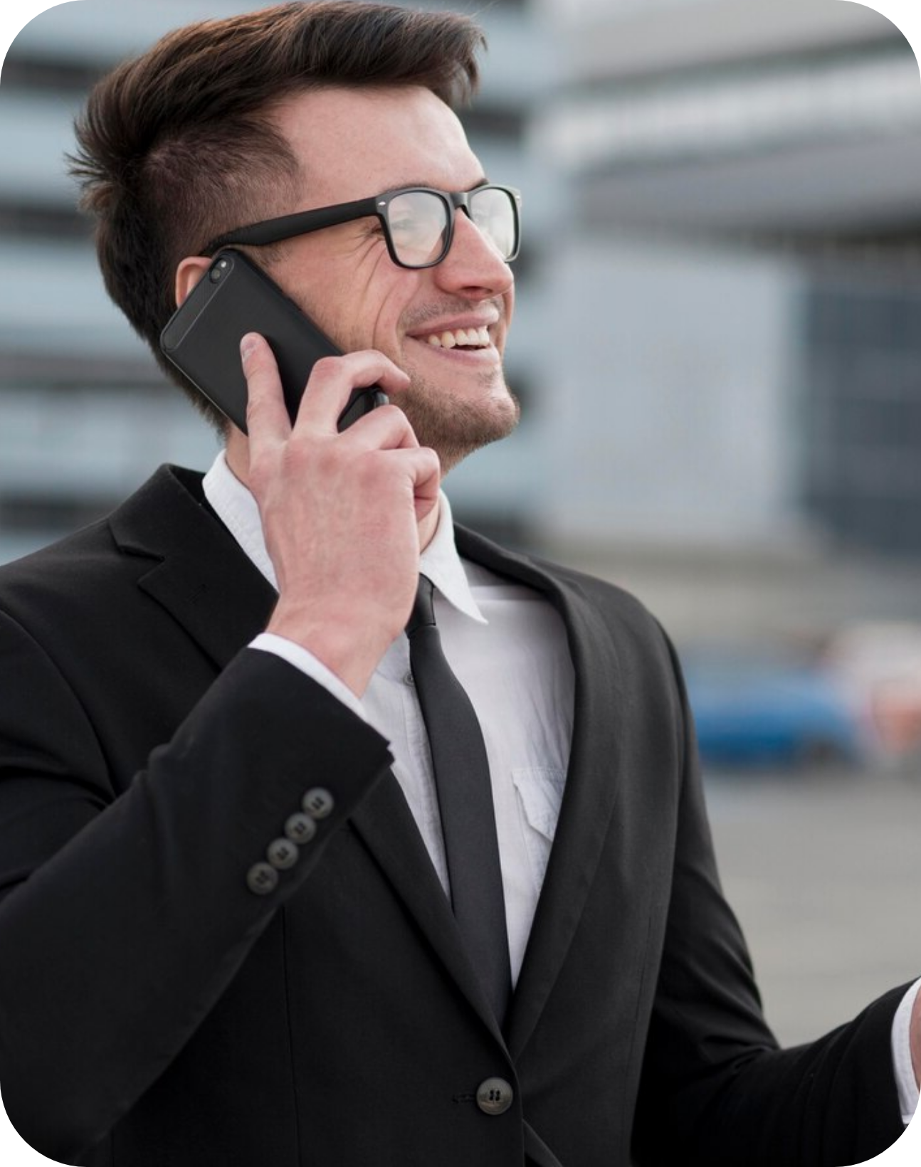 A man in a suit is talking on a cell phone