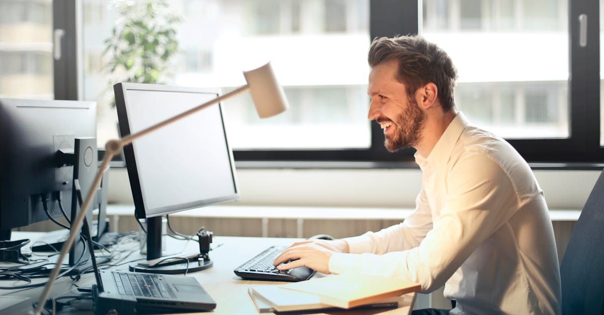 A man is sitting at a desk in front of a computer.
