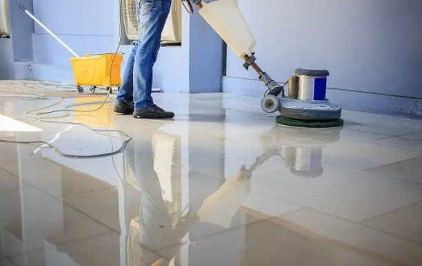 Professional janitor cleaning the floor of a shopping complex in Mackay, QLD.