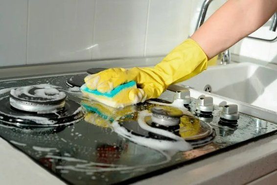 The kitchen stove of a residential home being cleaned by professional maid in Mackay, QLD.
