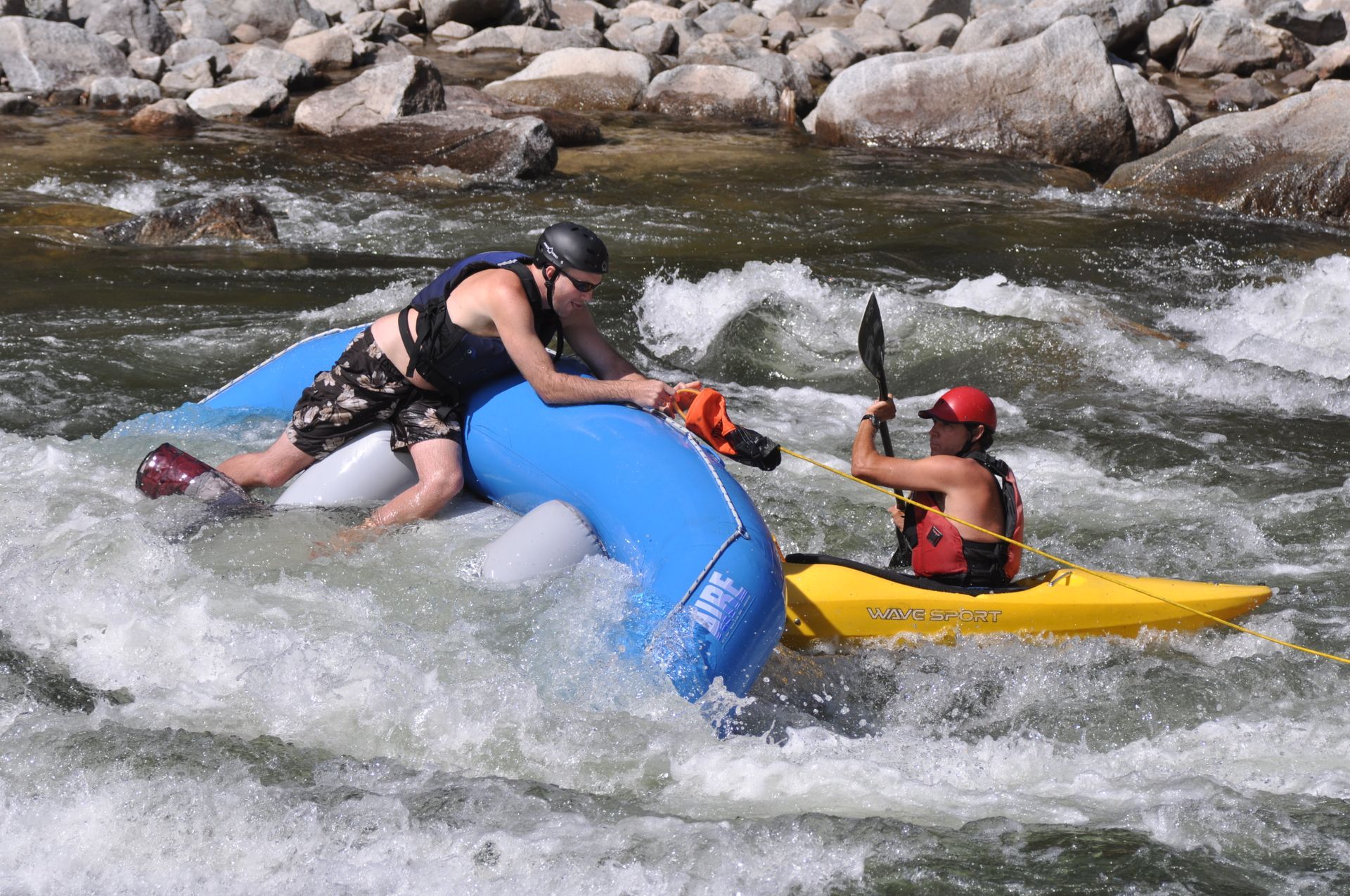 Swiftwater rescue of raft stuck on a rock