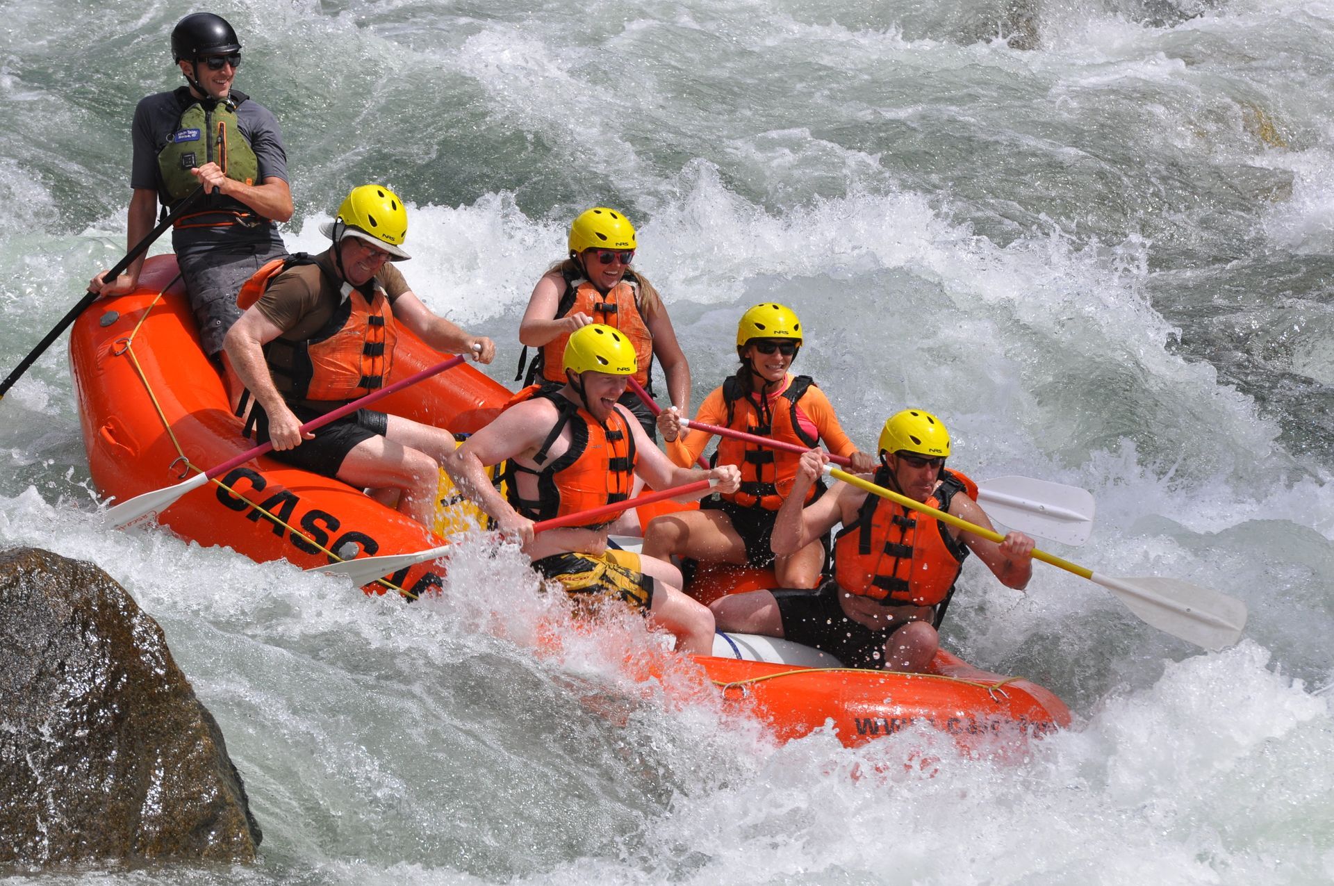 Orange raft going down rapids on South Fork of the Payette