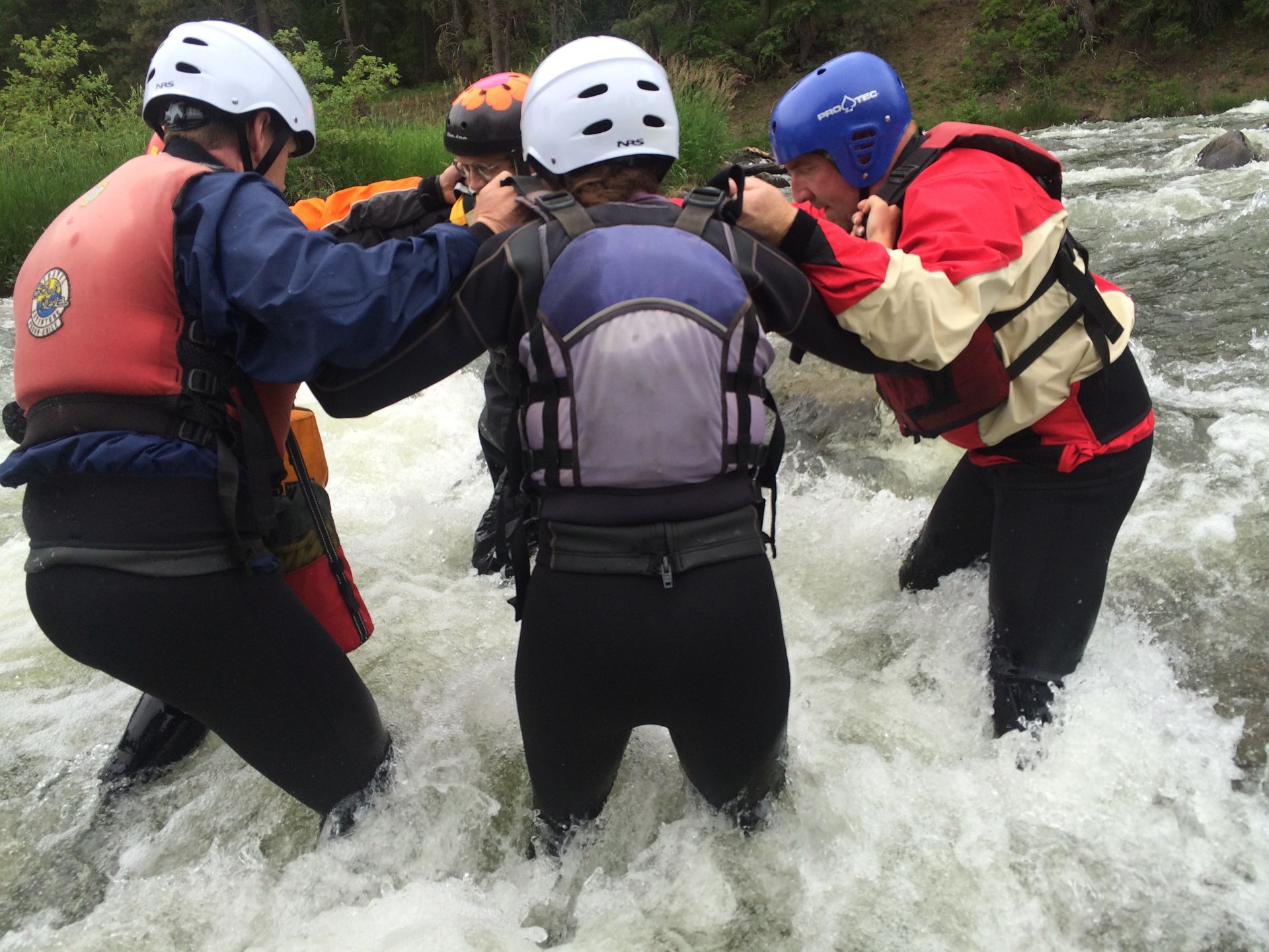 Group doing swiftwater rescue wading