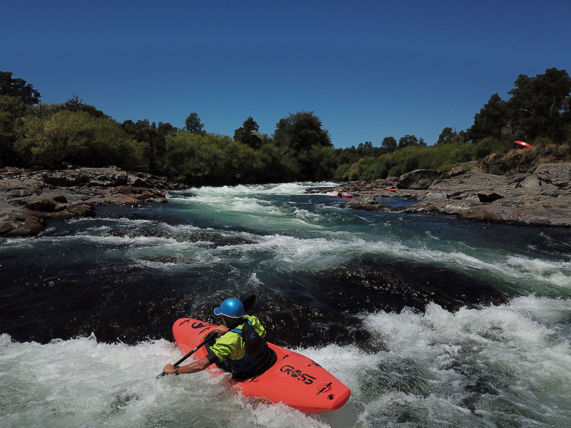 Whitewater kayak surfing wave in the river