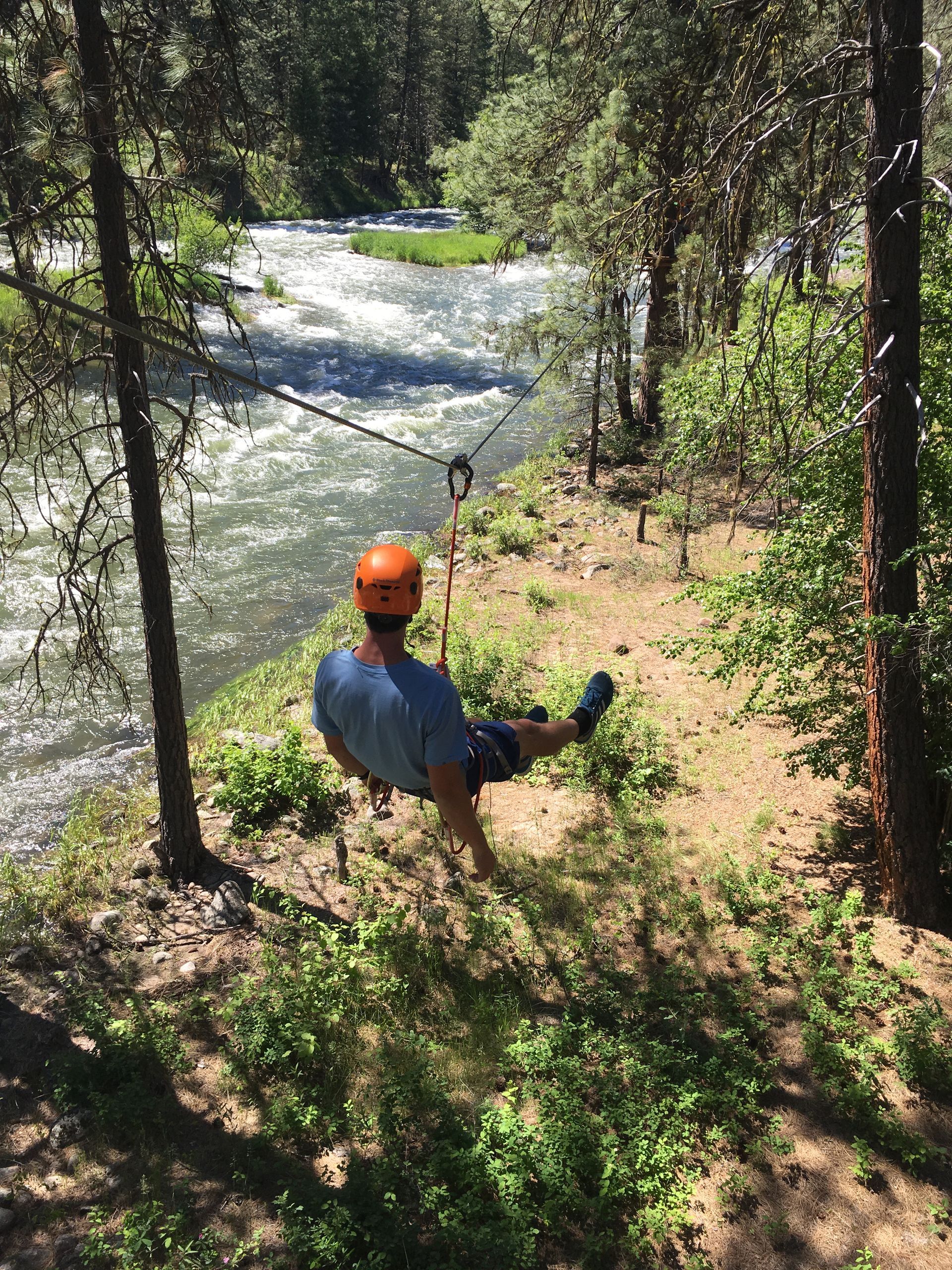Person on zipline near Payette River in Boise National Forest
