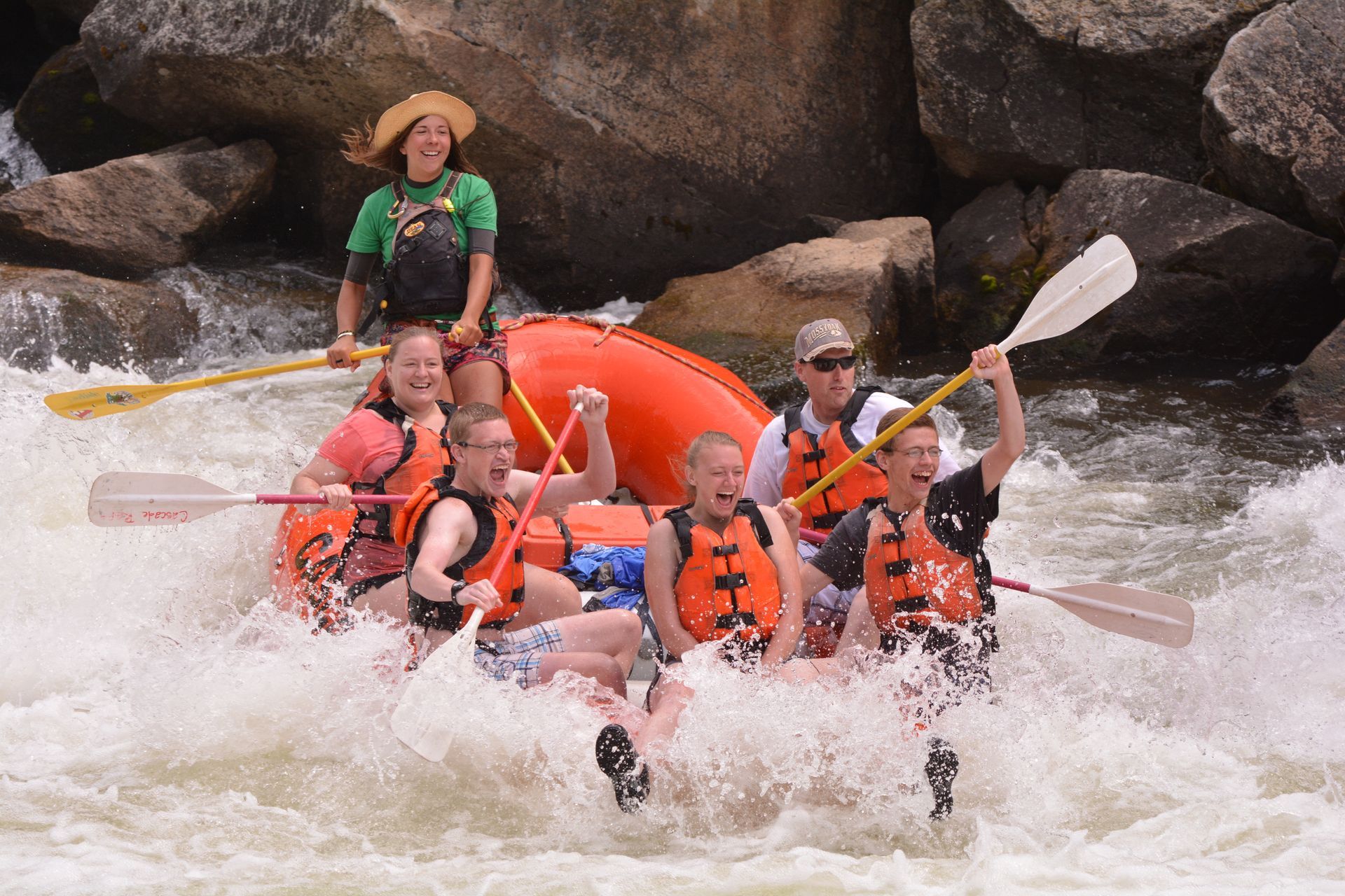 Fun guide taking family whitewater rafting