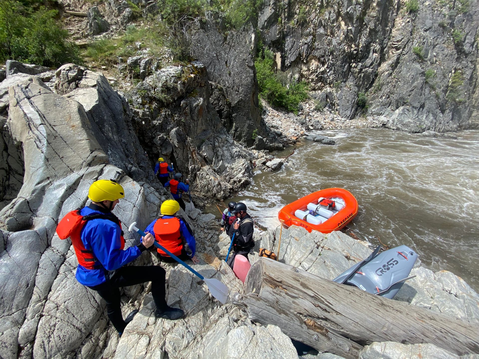 Rafters walking over rocks and cliffs near river on the Payette River