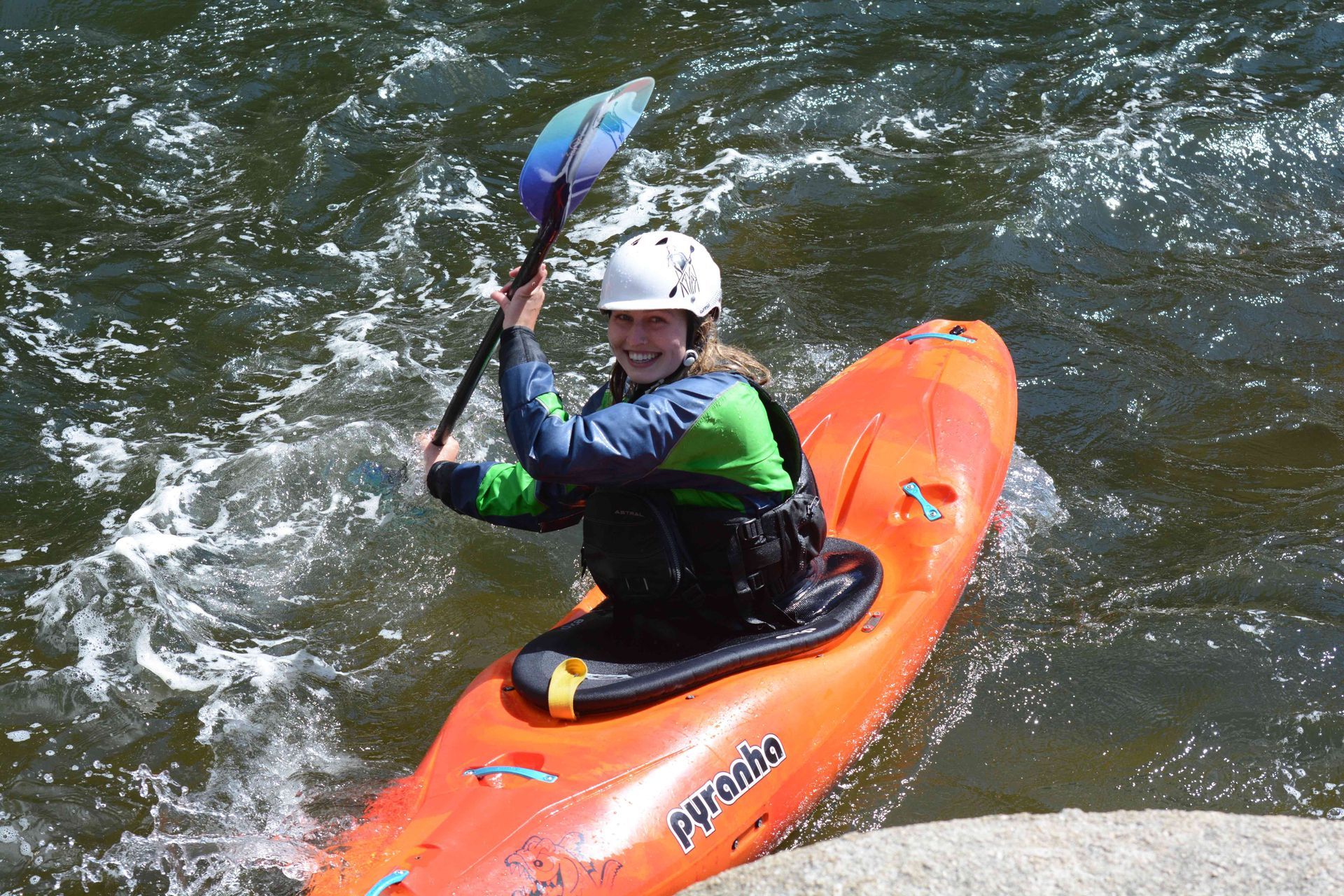 Kayaker in river smiling