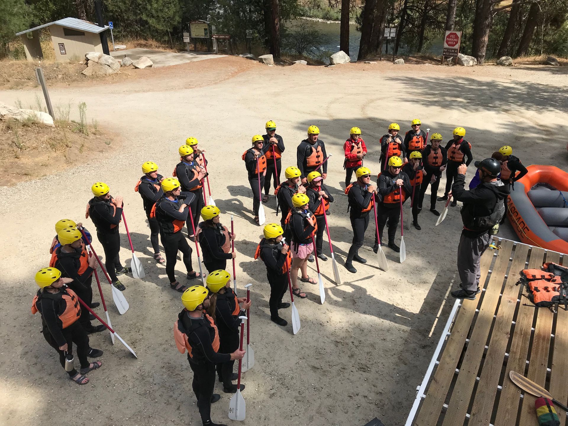 Group near river learning basics of whitewater rafting
