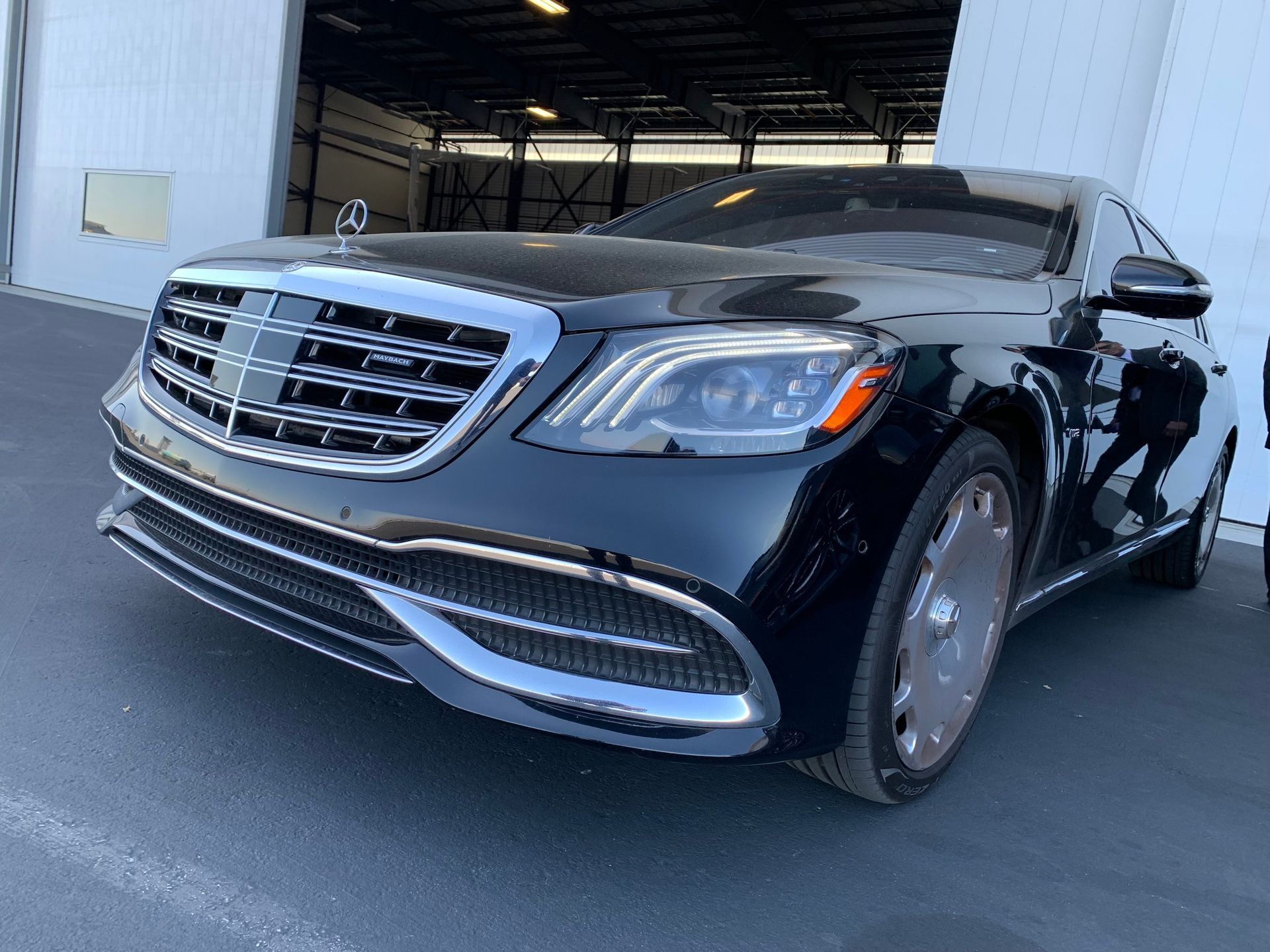 A black mercedes benz s class is parked in front of a building.