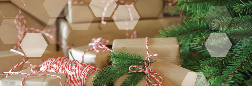 A close up of a christmas tree with gifts underneath it.
