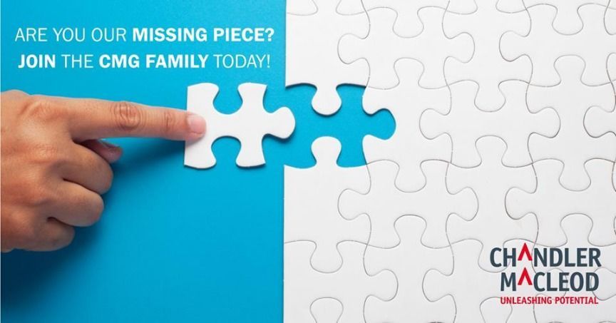 A person is pointing at a piece of a puzzle.