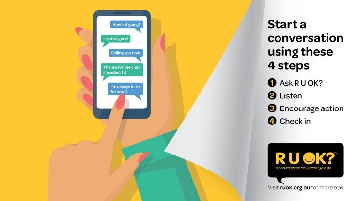 A woman is holding a cell phone with speech bubbles on it.