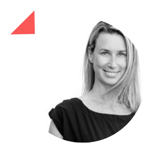 A woman in a black dress is smiling in a black and white photo