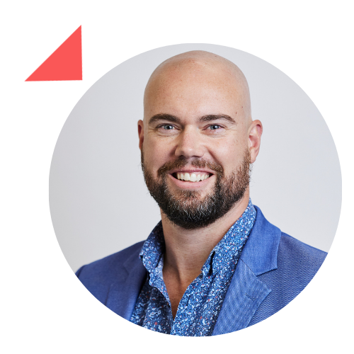 A bald man with a beard is smiling in a circle.