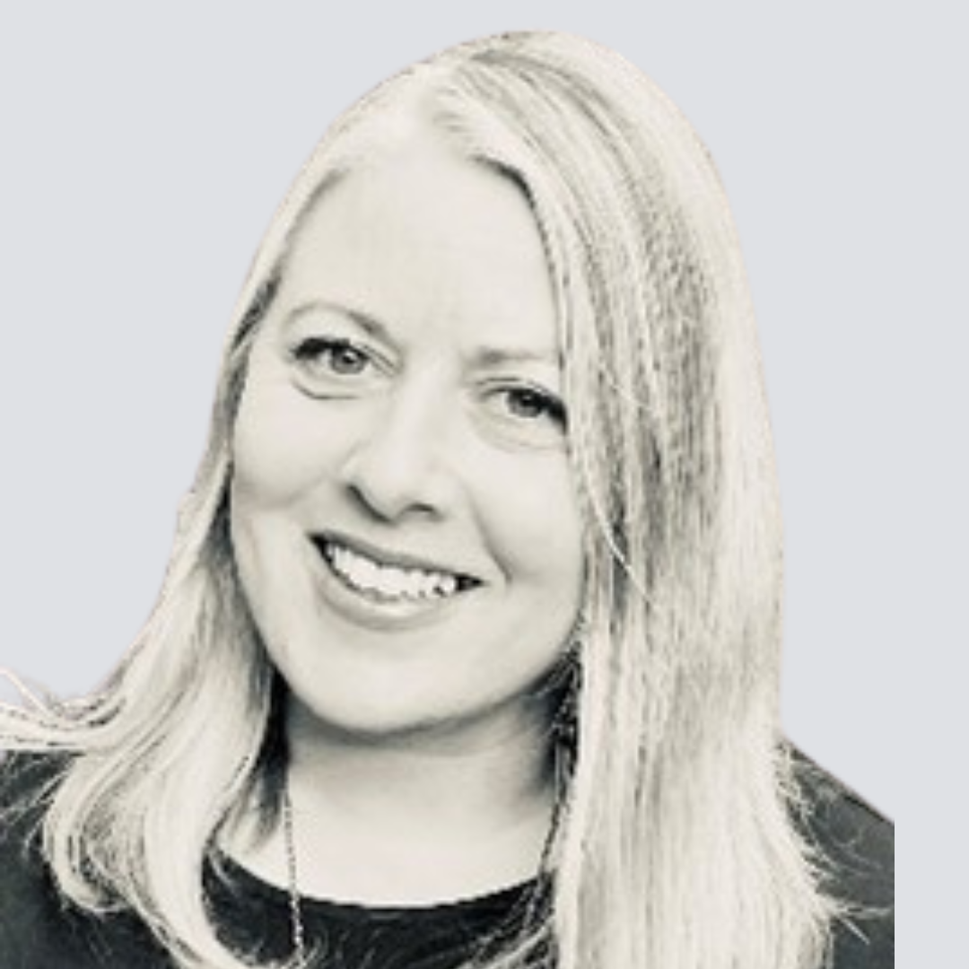 A woman with long blonde hair is smiling in a black and white photo.