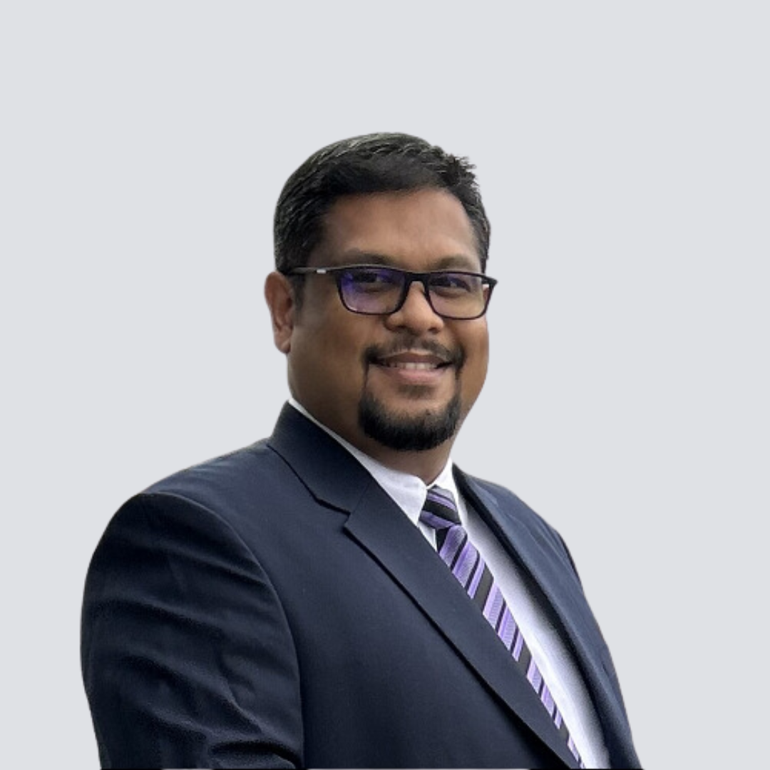 A man in a suit and tie is smiling for the camera