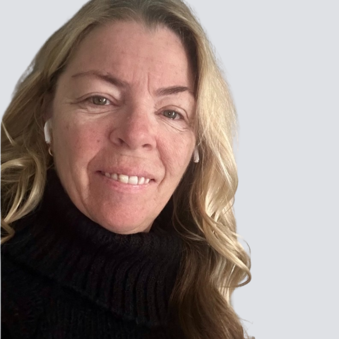 A woman wearing a black turtleneck sweater is smiling for the camera.