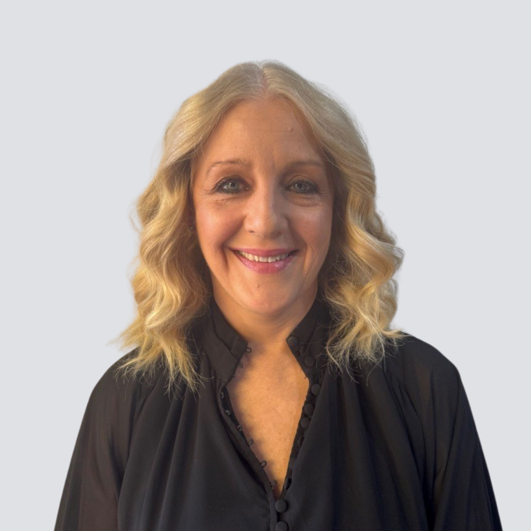 A woman with blonde hair is smiling and wearing a black shirt