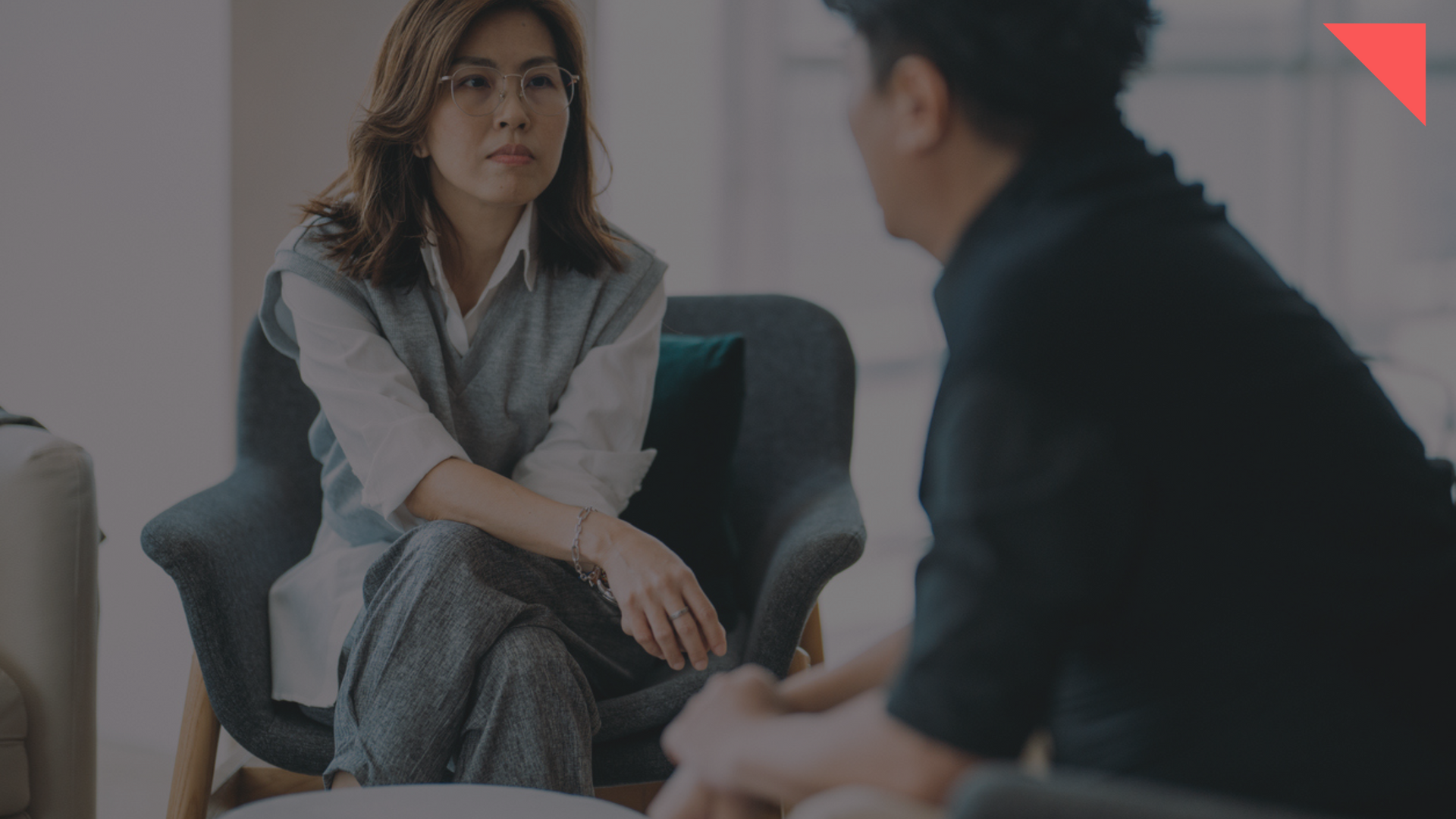 female sitting in work environment listening to male make a workplace complaint