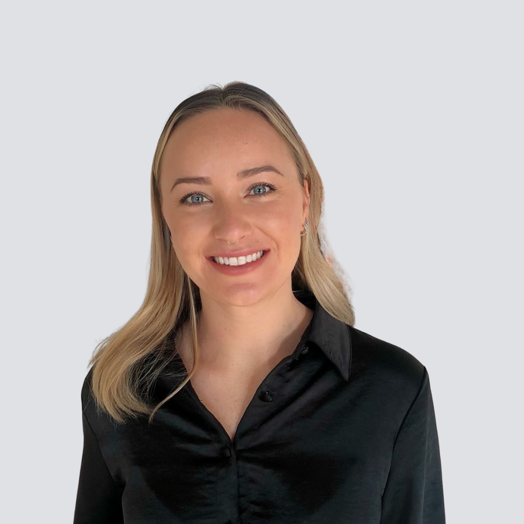 The woman is wearing a black shirt and smiling for the camera.