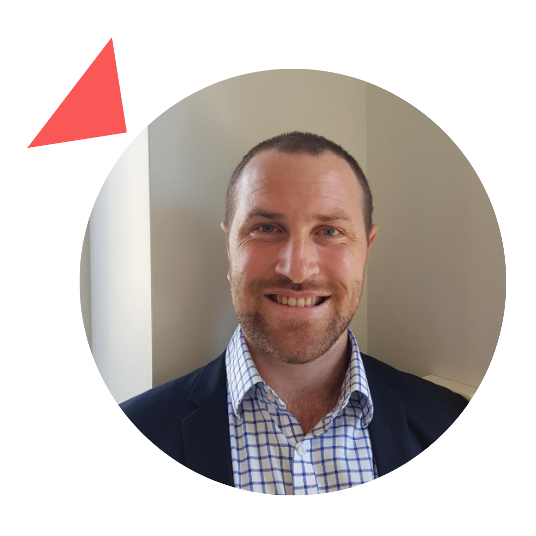 A man in a suit and plaid shirt is smiling in a circle