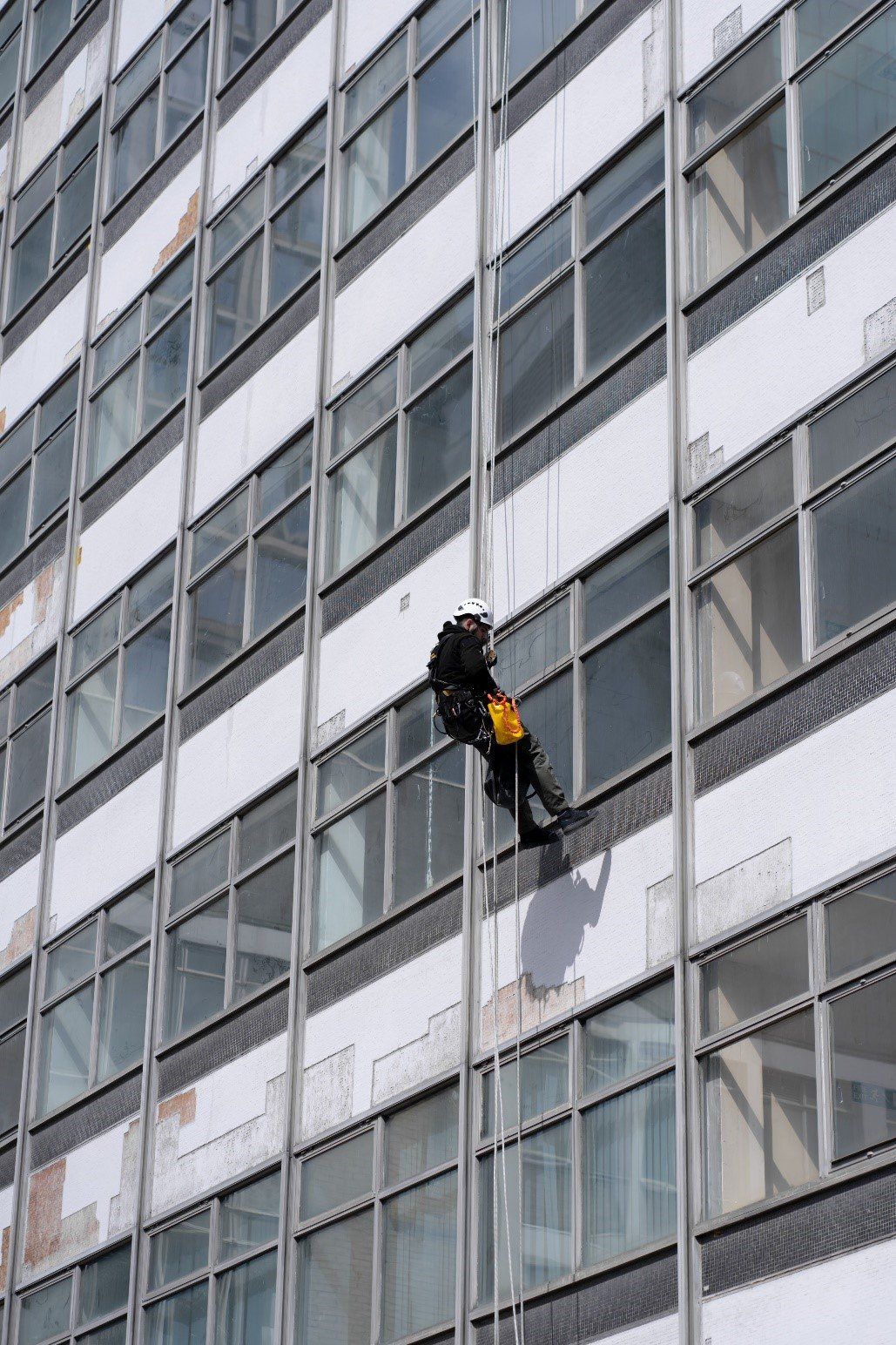 A worker hanging on the building