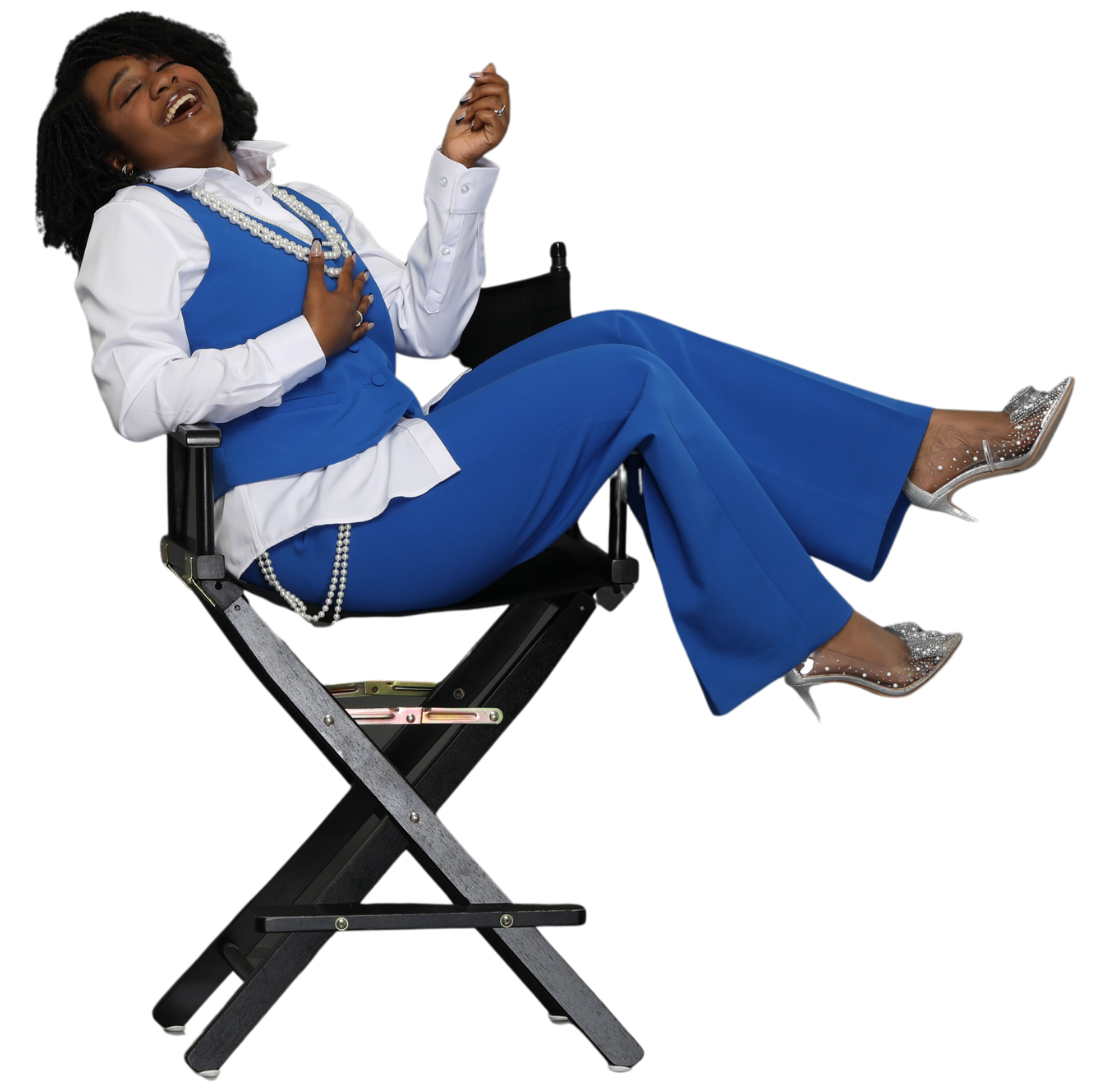 Londyn in blue outfit reclining on a folding director’s chair against a white background