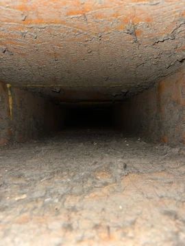 It looks like a tunnel with a lot of dirt coming out of it.