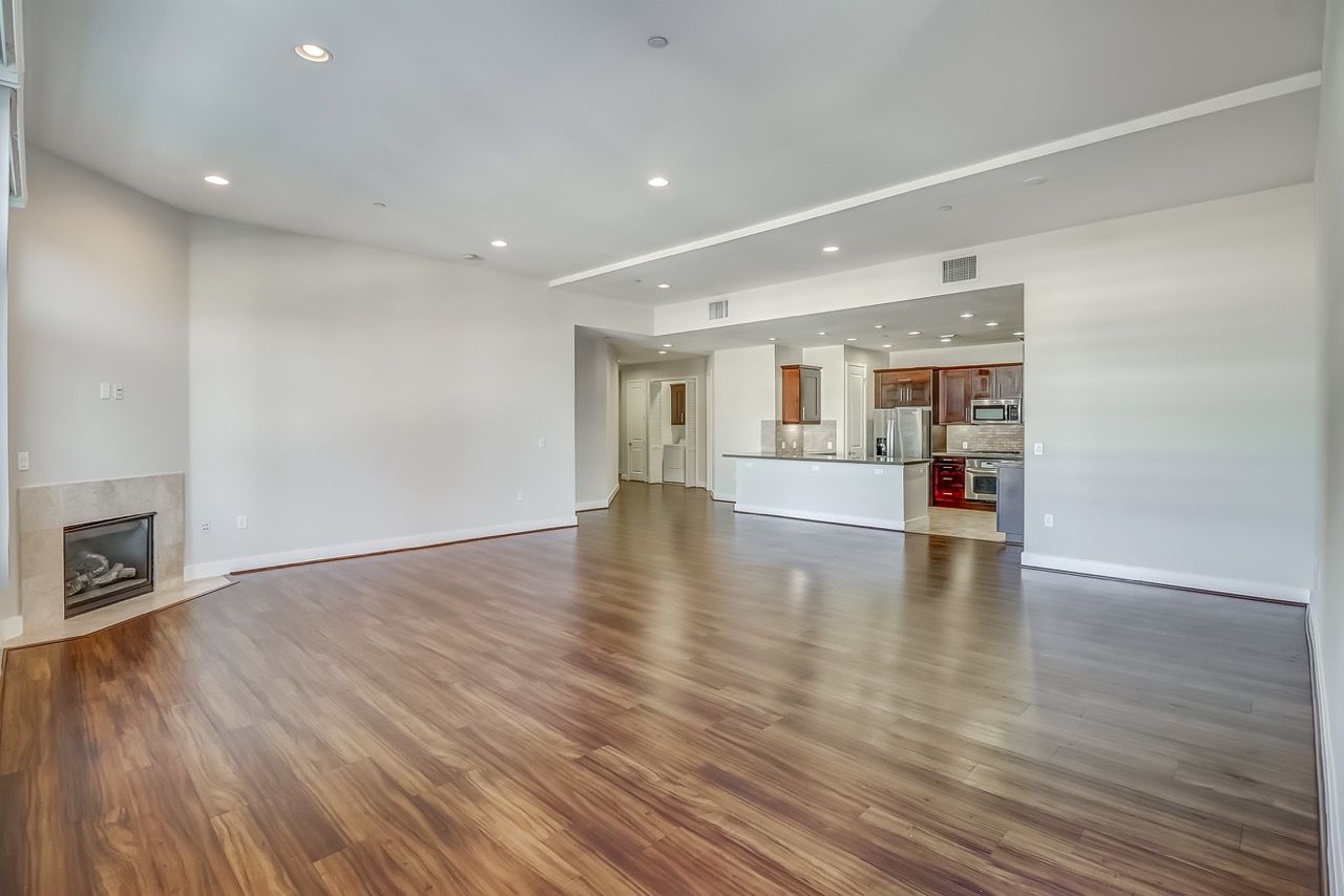 Axis unfurnished living room with view of kitchen