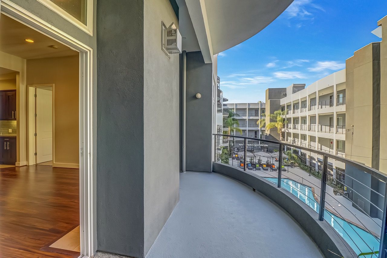 Axis apartment balcony with view of pool