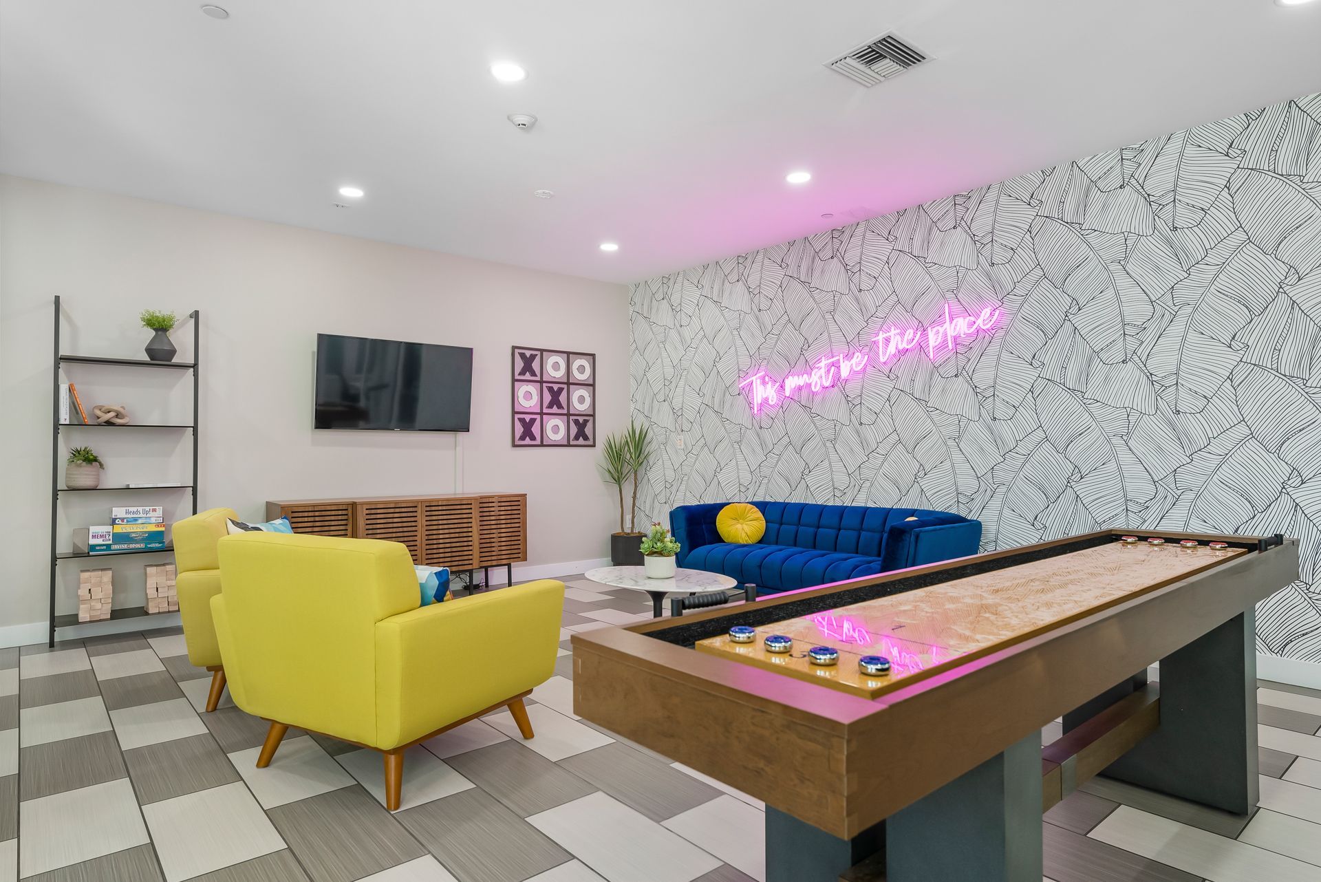 Community room with shuffle board and chairs