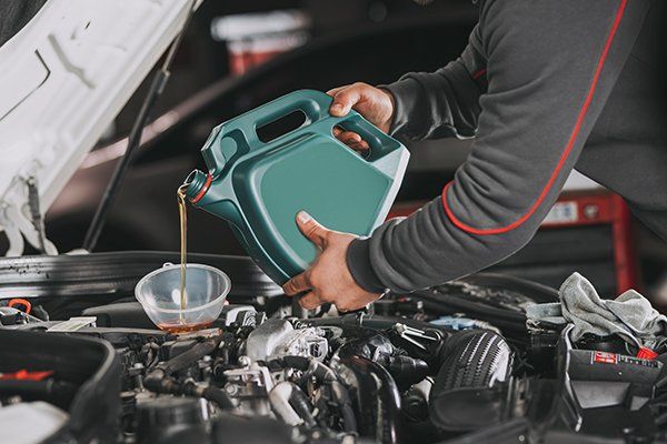 Pouring Oil to Car Engine — St. Louis Park, MN — Eliot Park Auto Service