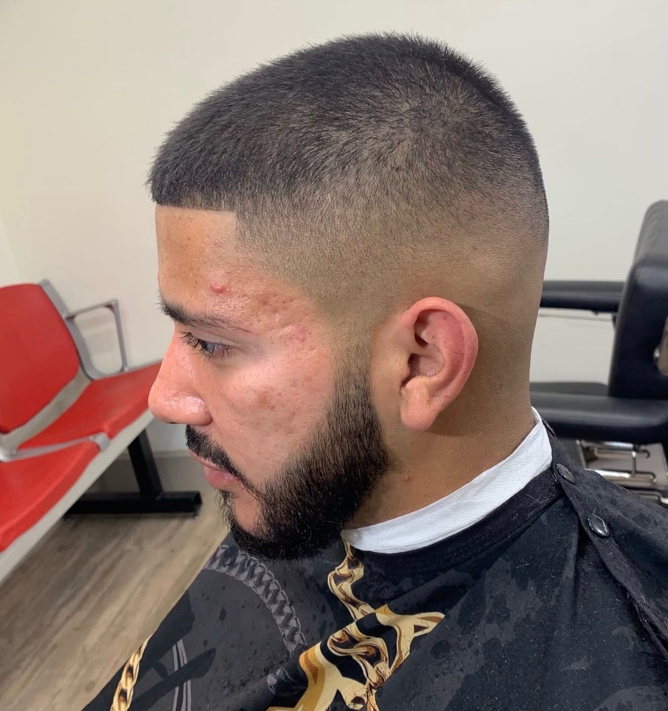 Straight razor shaving a bearded face, applying shaving cream.