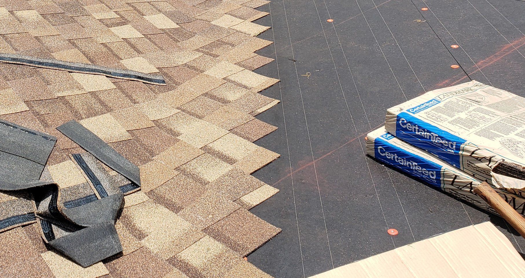 A person is working on a roof with a hose.