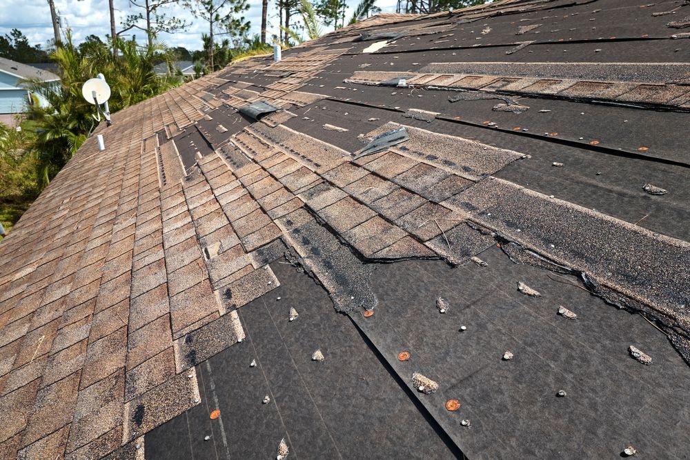 A close up of a roof with a lot of shingles missing.