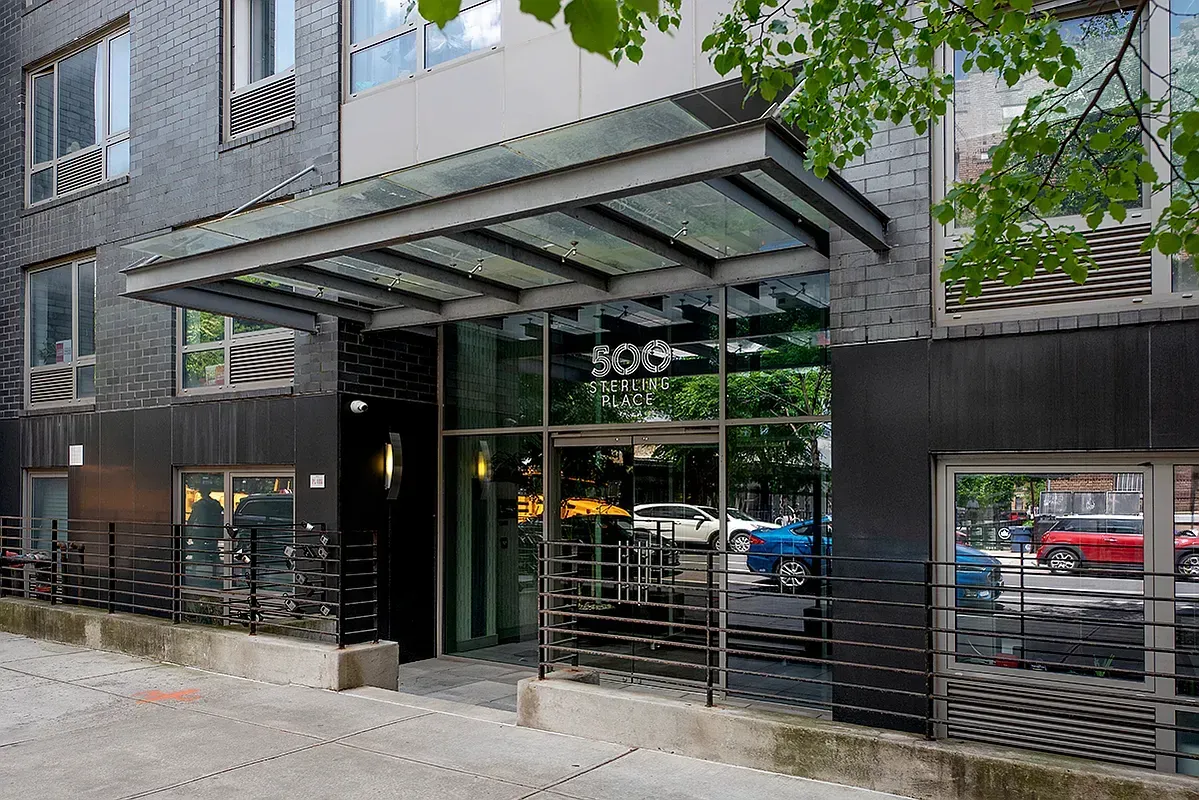 A large building with a glass canopy over the entrance.