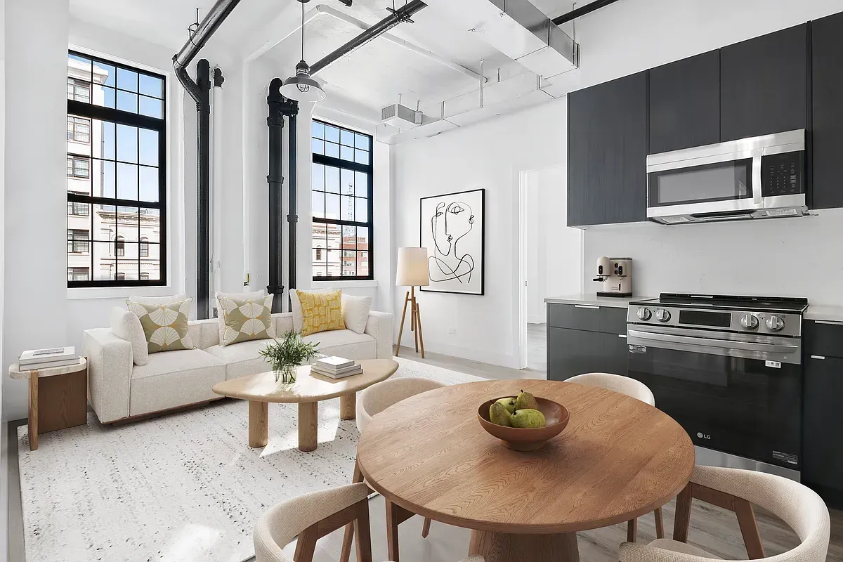 A living room with a couch , table , chairs and a microwave.