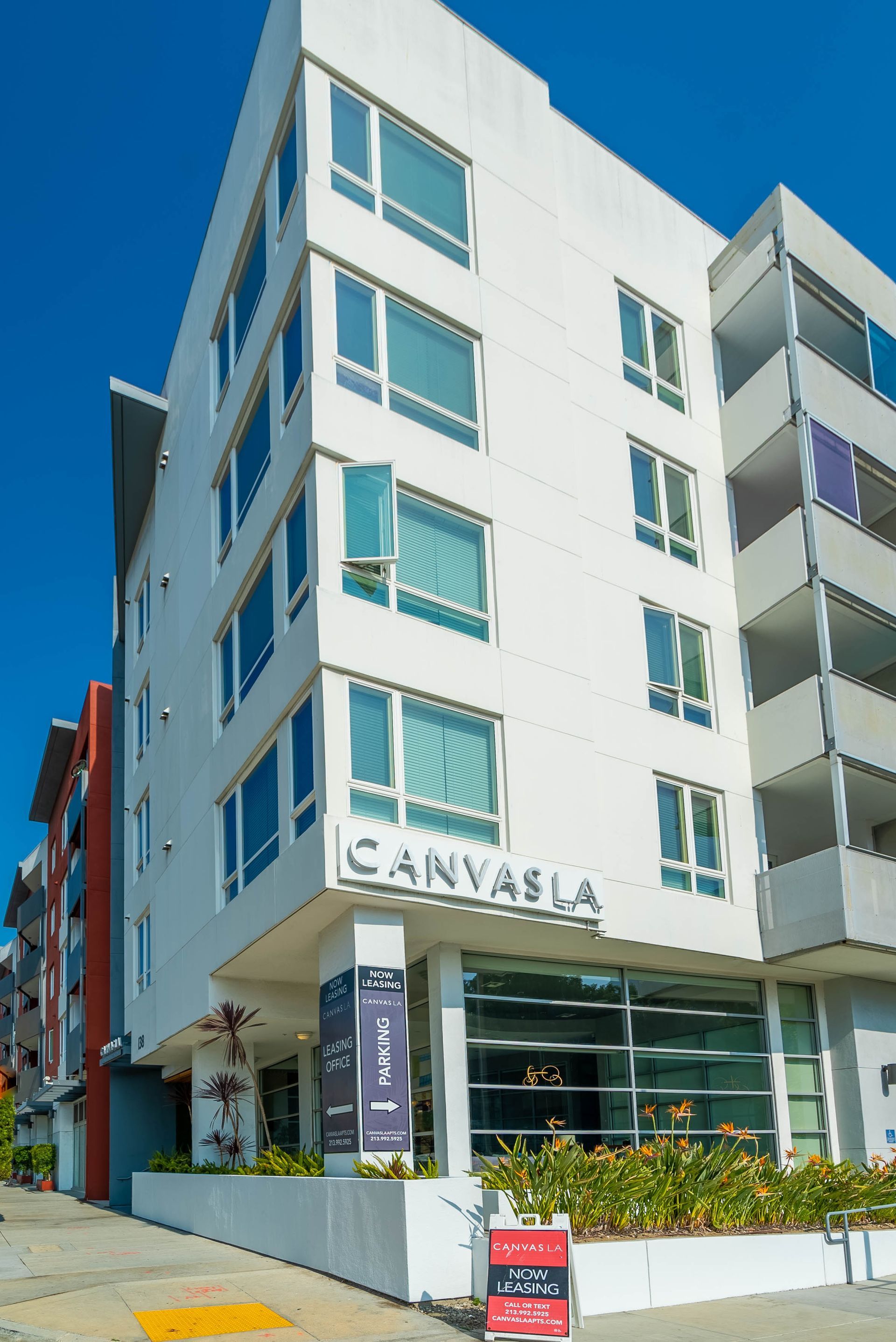 A large white building with a lot of windows on a sunny day.