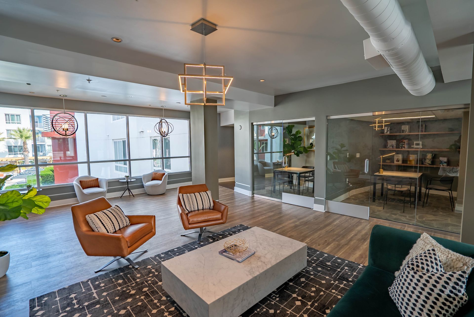 A living room with a couch , chairs , and a coffee table.