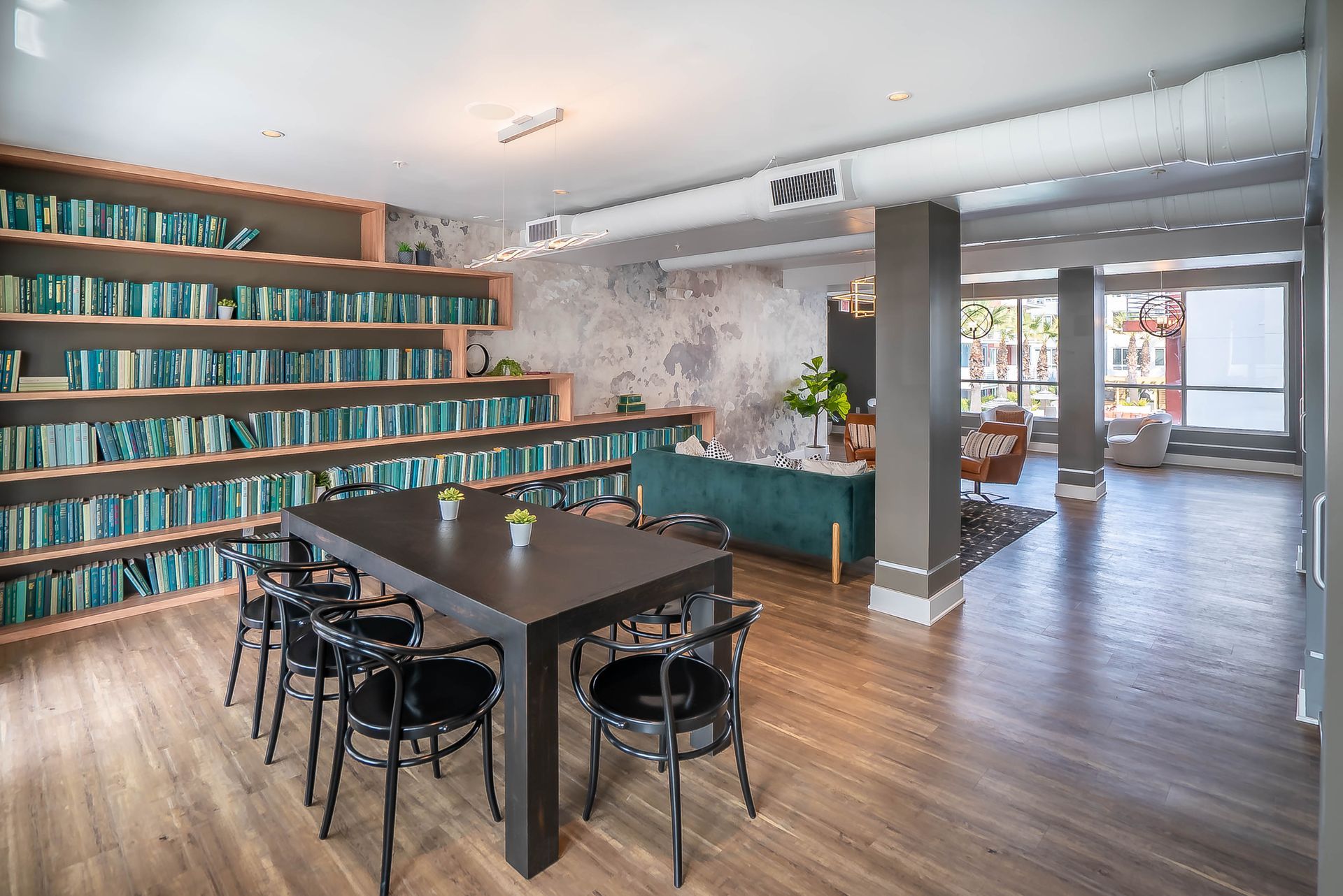 There is a table and chairs in the middle of the room.