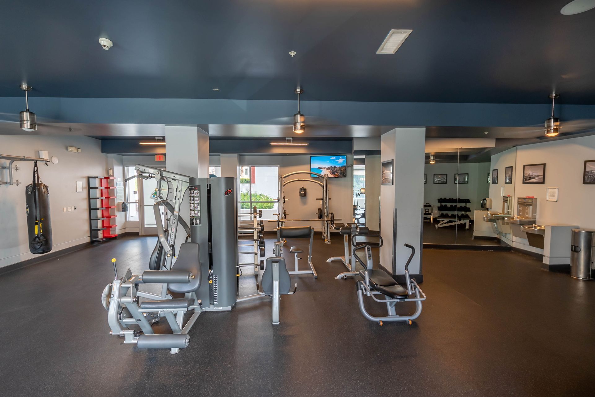 A large gym filled with lots of exercise equipment.