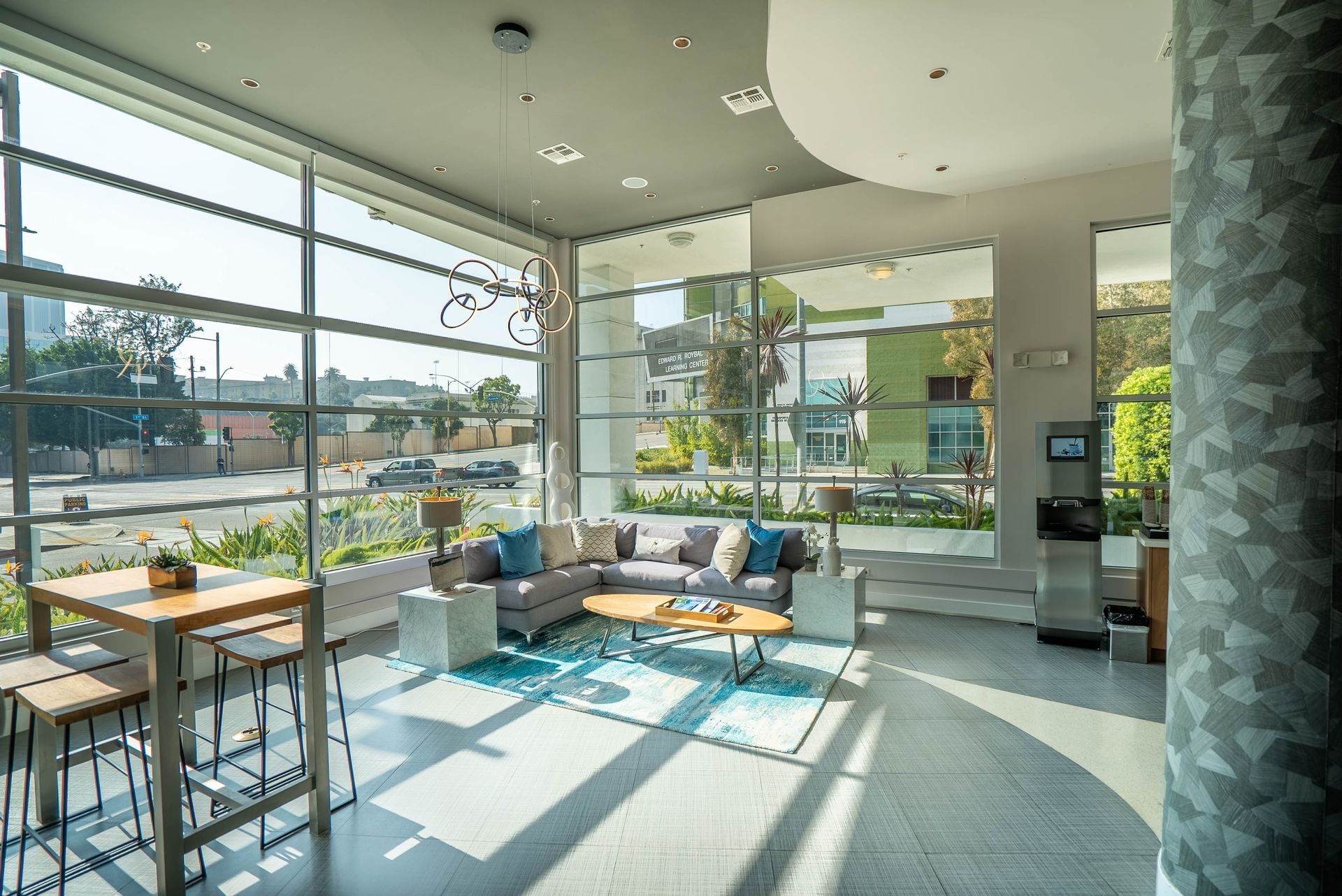 A living room with a lot of windows and a couch